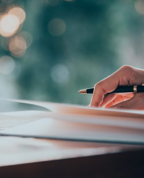 Close up women hand on writing on notebook and work with smart phone